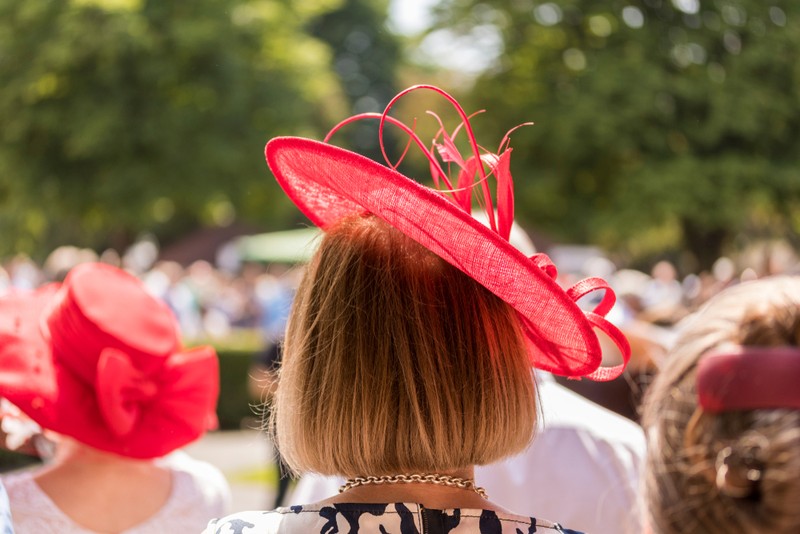 Female Racegoer with Red Fascinator