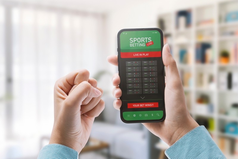 Hand Holding Smartphone with Sports Betting