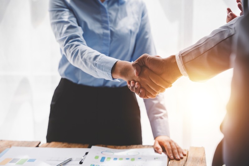 Business Handshake Across Desk