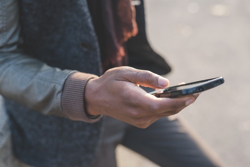 Man with Leather Jacket Using Phone
