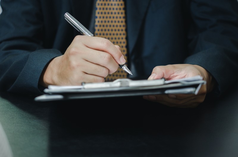 Man in Suit with Clipboard