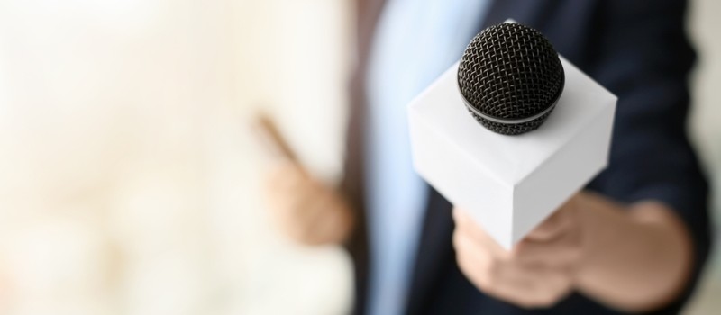 Female Journalist Holding Microphone