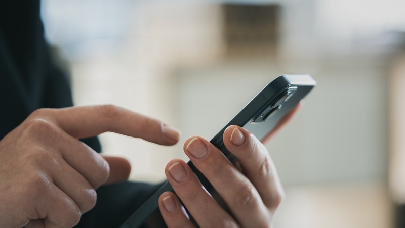 Hand of Person About to Press Phone Button